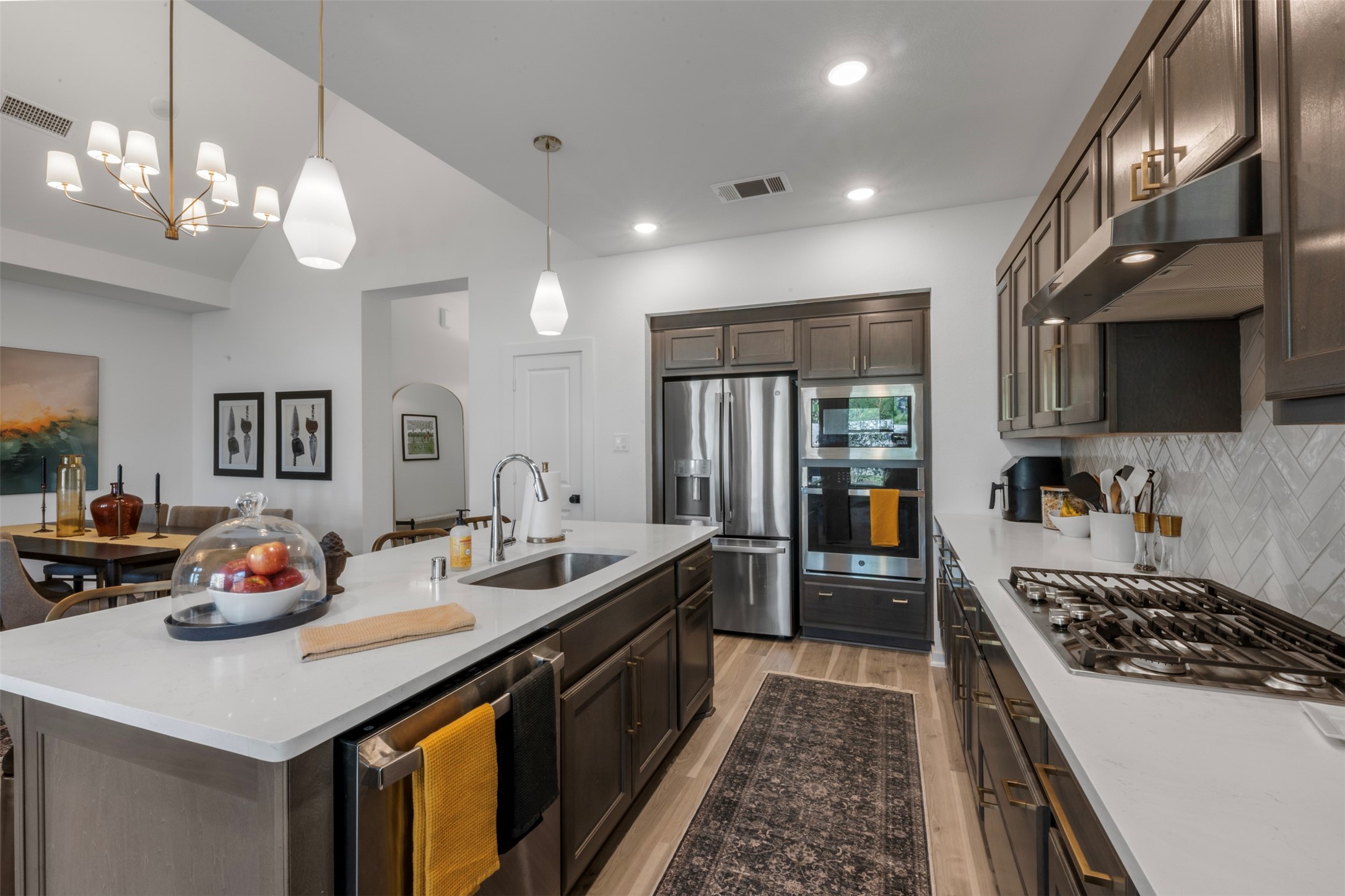 15650 Turtlehead Trail Conroe, TX 77302 - Photo 13 of 37 a kitchen with a sink a stove and chairs