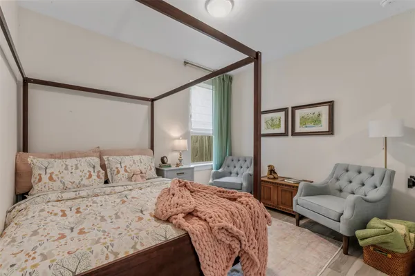 a kitchen with a refrigerator and wooden floor