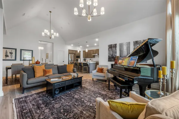 a living room with furniture a rug and a chandelier