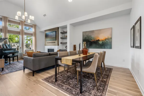 a living room with furniture a chandelier and a flat screen tv