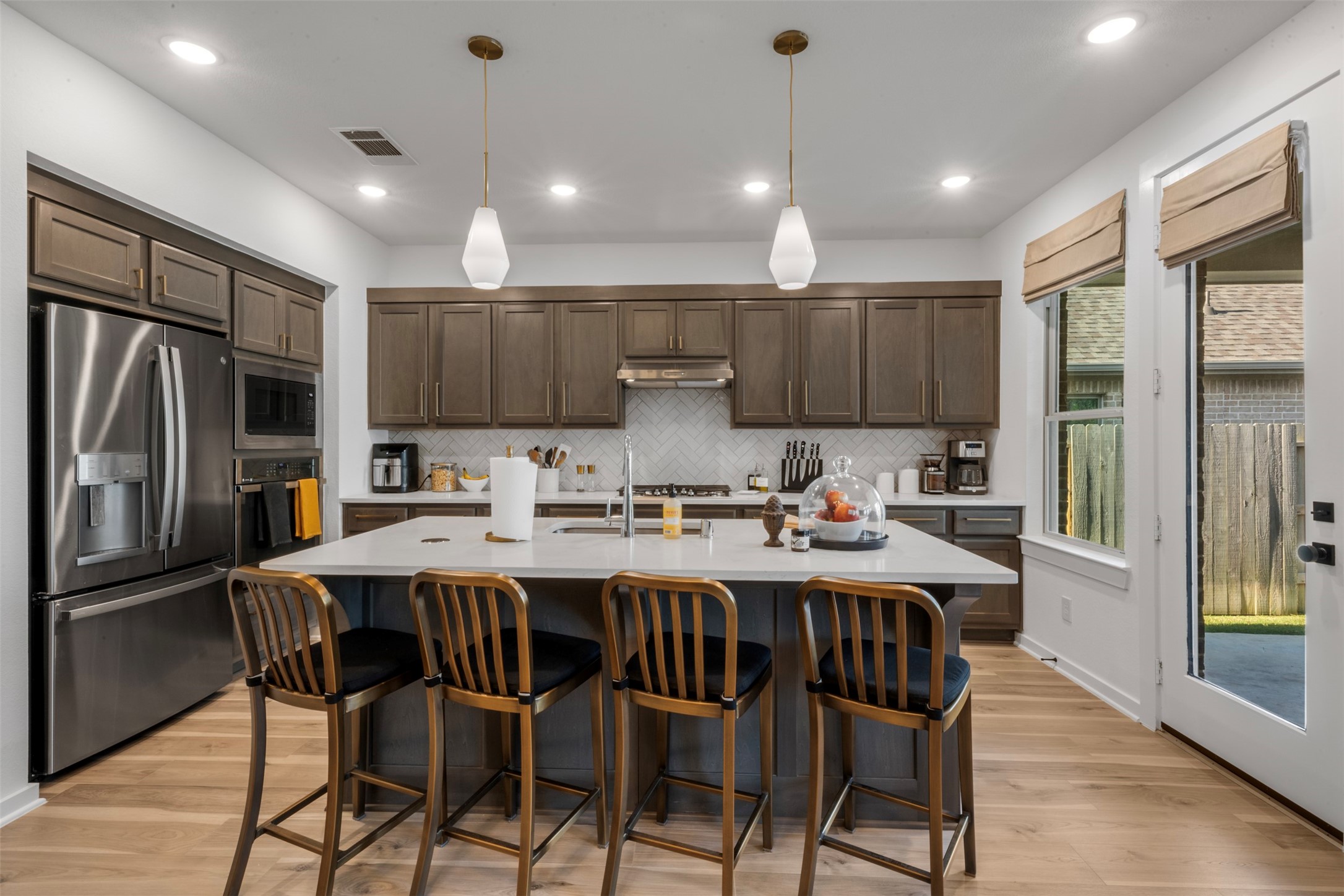 15650 Turtlehead Trail Conroe, TX 77302 - Photo 7 of 37 a kitchen with granite countertop a center island stainless steel appliances cabinets and a counter top space