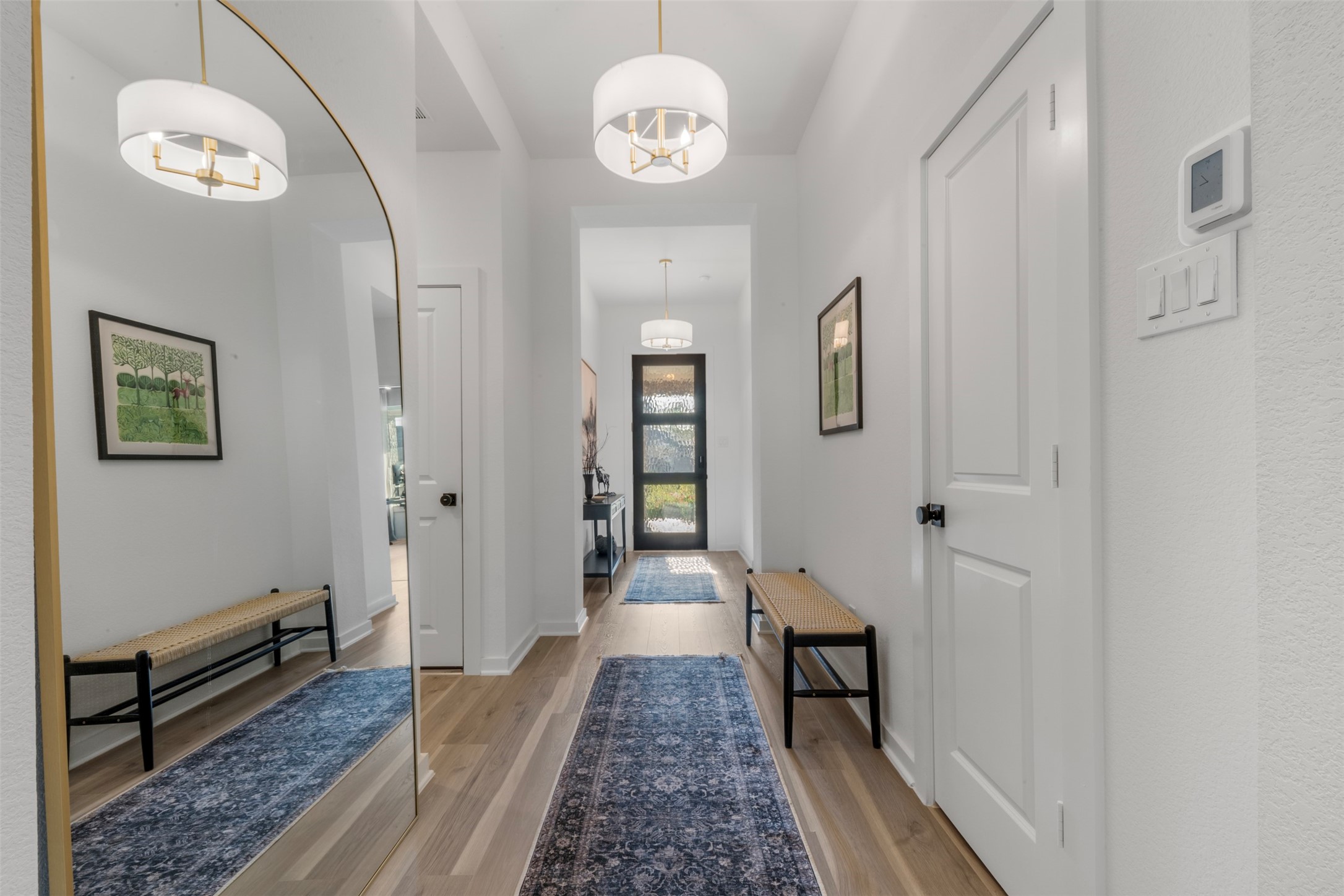 15650 Turtlehead Trail Conroe, TX 77302 - Photo 10 of 37 a view of a hallway with wooden floor and a chandelier