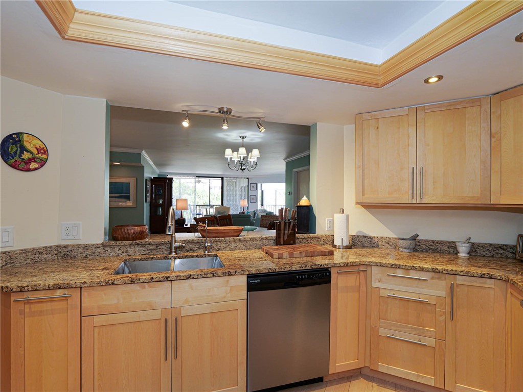 1850 Bay Road, Unit 3G Vero Beach, FL 32963 - Photo 11 of 36 a kitchen with kitchen island granite countertop a sink cabinets and stainless steel appliances
