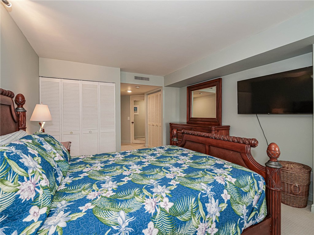 1850 Bay Road, Unit 3G Vero Beach, FL 32963 - Photo 21 of 36 a bedroom with a bed and a flat screen tv