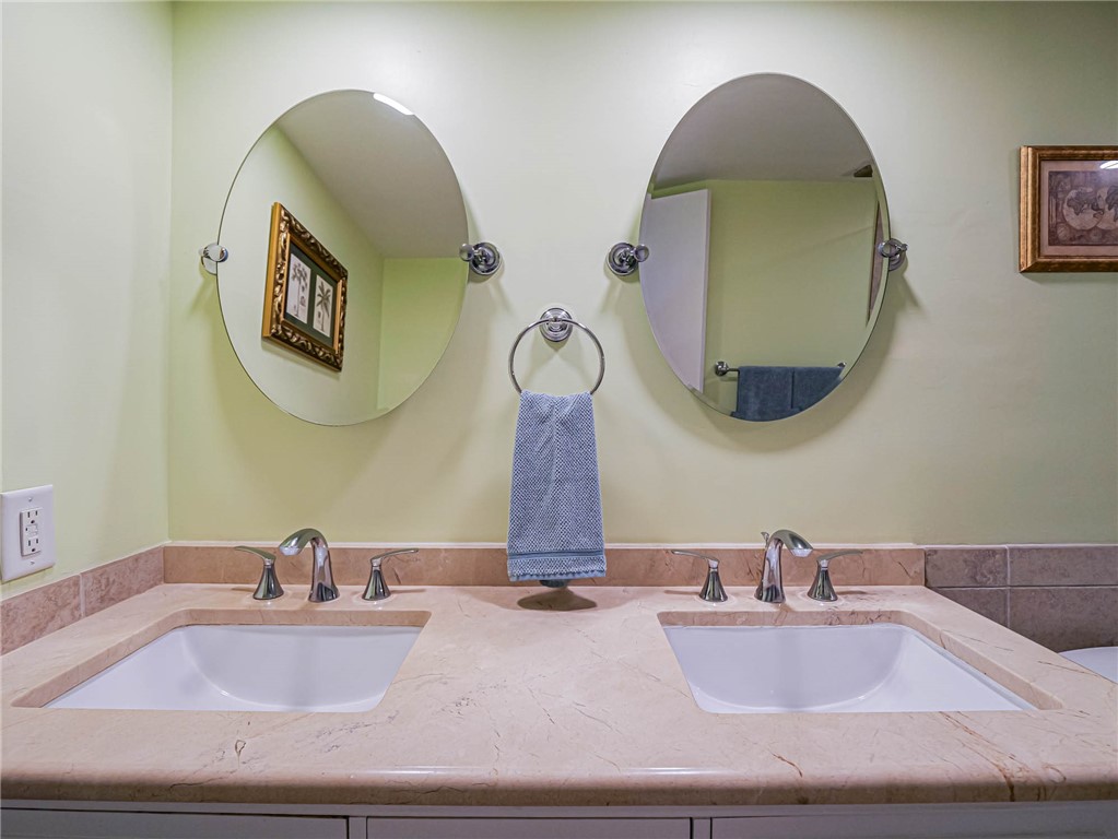 1850 Bay Road, Unit 3G Vero Beach, FL 32963 - Photo 22 of 36 a bathroom with sink and mirror