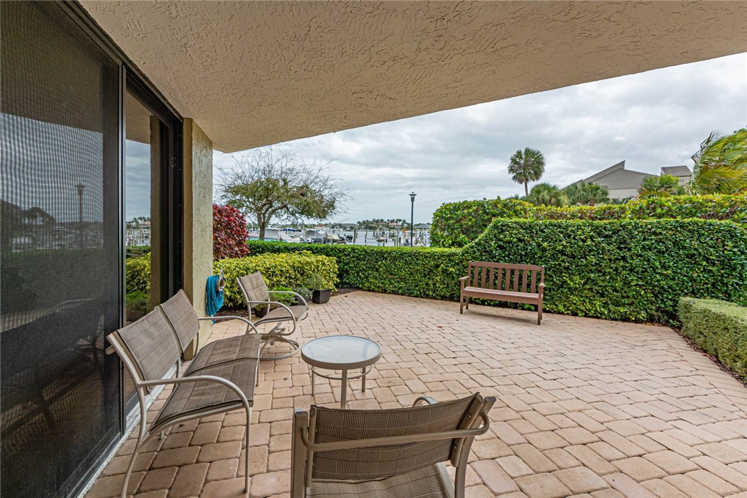 1850 Bay Road, Unit 3G Vero Beach, FL 32963 - Photo 3 of 36 a view of a patio with a table chairs and a potted plant