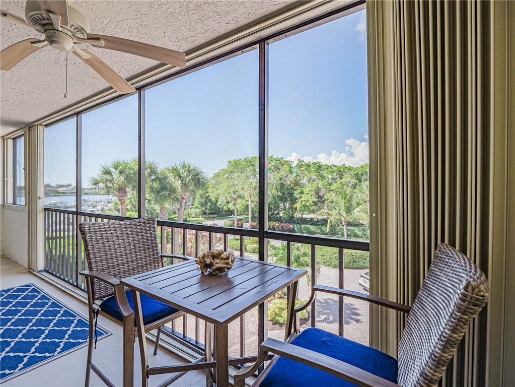 1850 Bay Road, Unit 3G Vero Beach, FL 32963 - Photo 33 of 36 a view of a balcony with a table and chairs