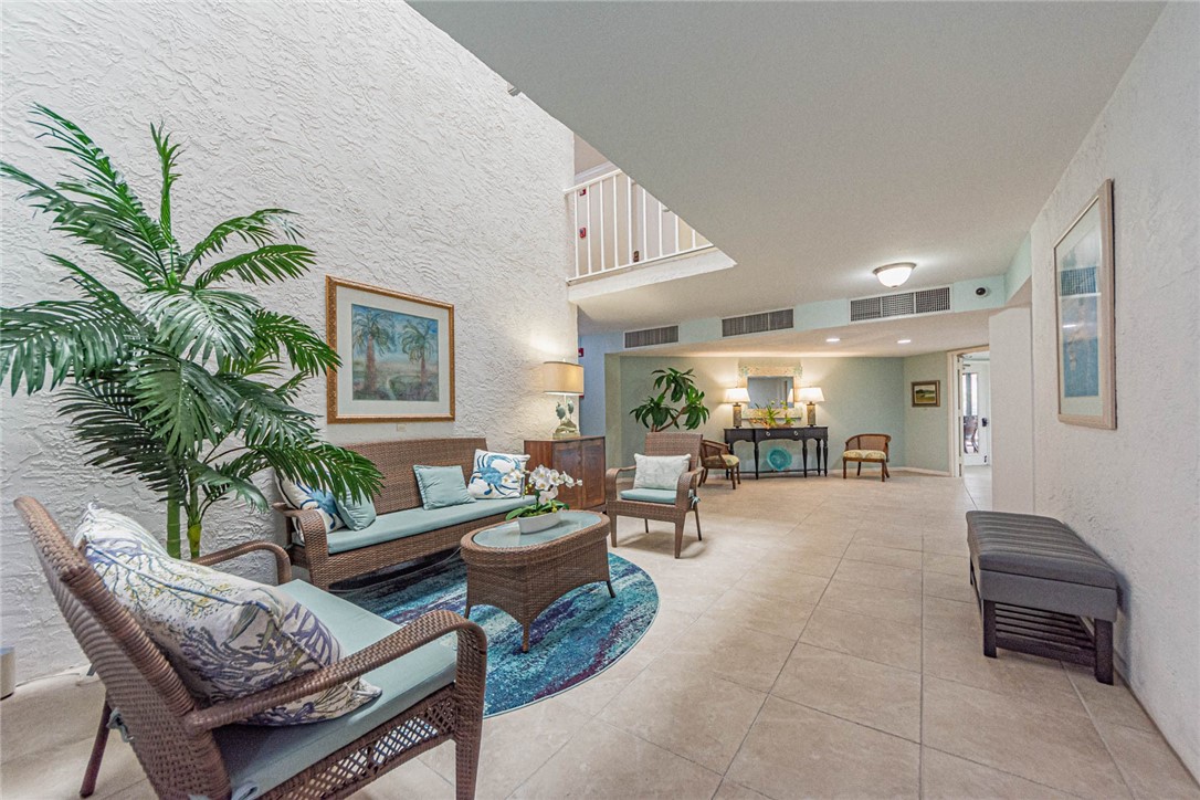 1850 Bay Road, Unit 3G Vero Beach, FL 32963 - Photo 5 of 36 a living room with furniture and a potted plant