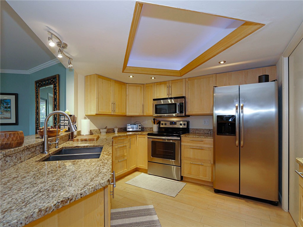 1850 Bay Road, Unit 3G Vero Beach, FL 32963 - Photo 10 of 36 a kitchen with stainless steel appliances granite countertop a refrigerator and a stove