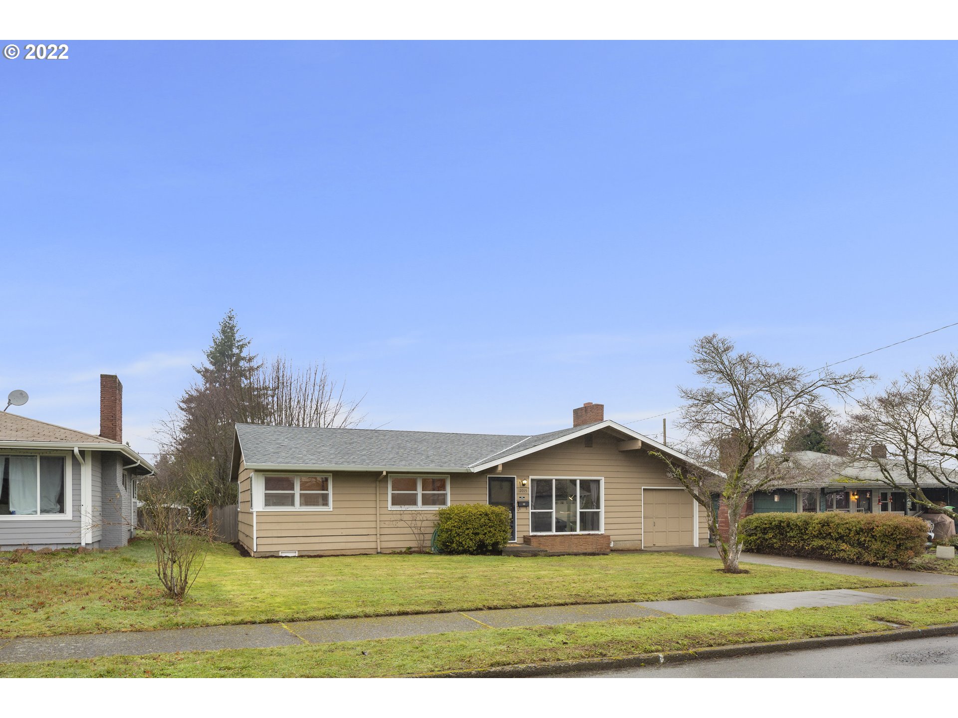 12015 Northeast Morris Street Portland, OR 97220 - Photo 22 of 23 a front view of a house with a yard
