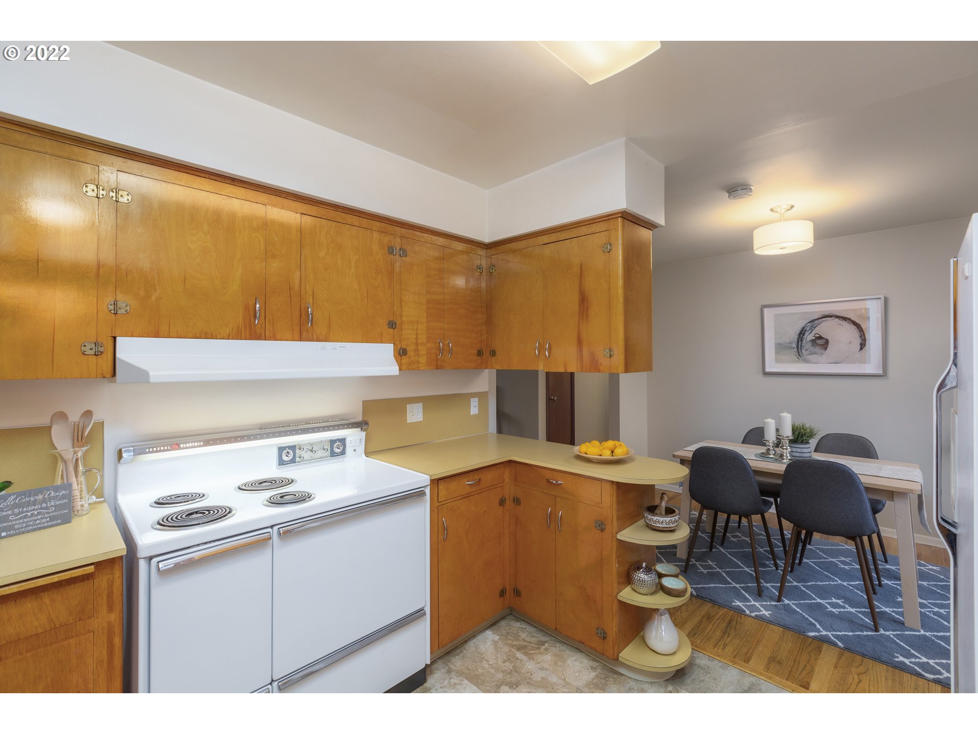 12015 Northeast Morris Street Portland, OR 97220 - Photo 8 of 23 a kitchen with a stove a refrigerator and a dining table