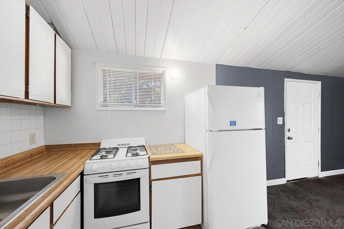 5616 Riley Street San Diego, CA 92110 - Photo 18 of 22 a kitchen with a stove a refrigerator and a stove