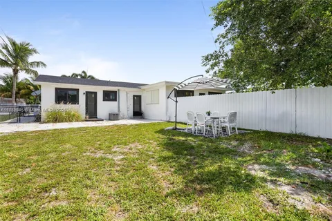 a view of a house with a yard patio and swimming pool