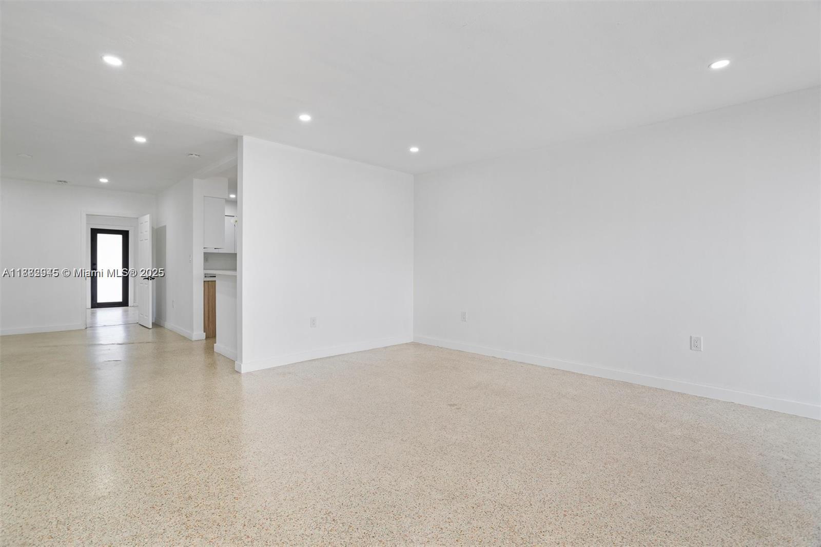 70 Northeast 186th Terrace Miami, FL 33179 - Photo 19 of 32 a view of an empty room with a kitchen