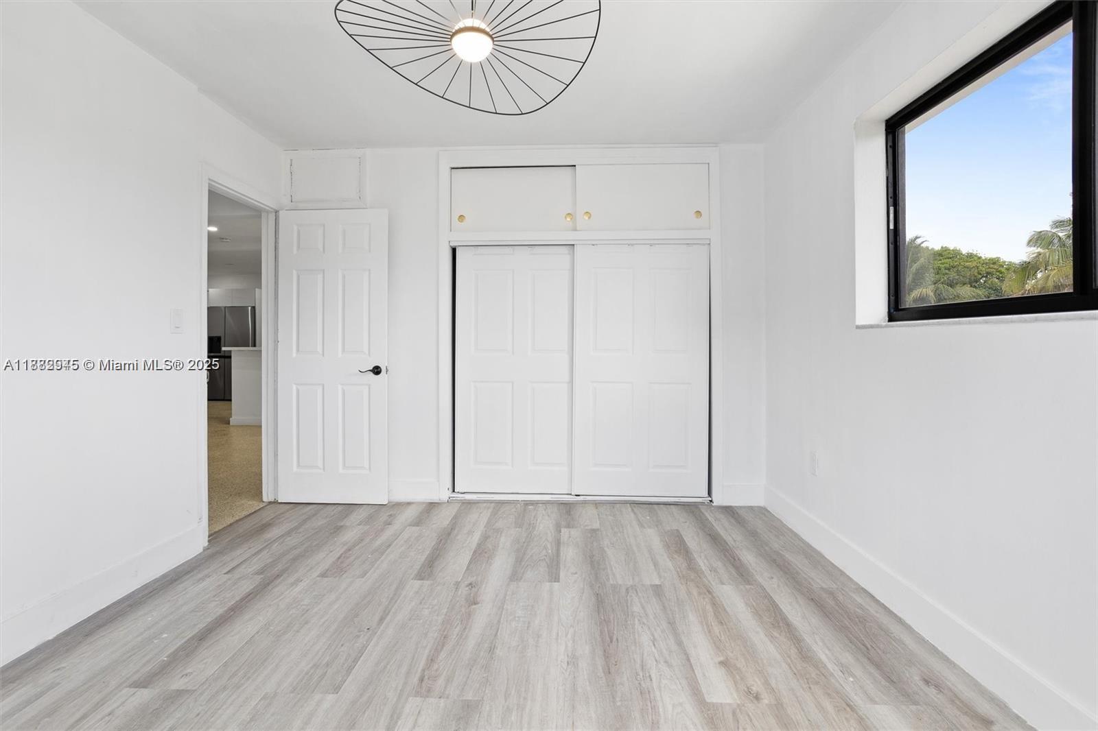 70 Northeast 186th Terrace Miami, FL 33179 - Photo 22 of 32 a view of empty room with wooden floor