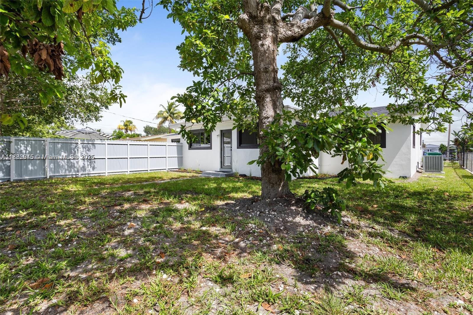 70 Northeast 186th Terrace Miami, FL 33179 - Photo 30 of 32 a view of a backyard with a tree