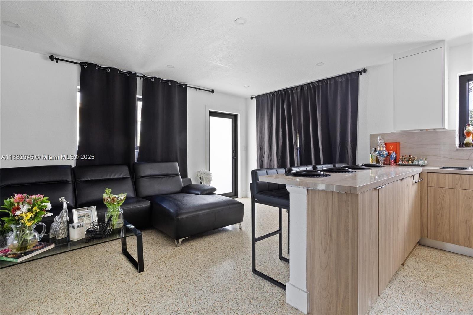 70 Northeast 186th Terrace Miami, FL 33179 - Photo 6 of 32 a living room with furniture and a flat screen tv