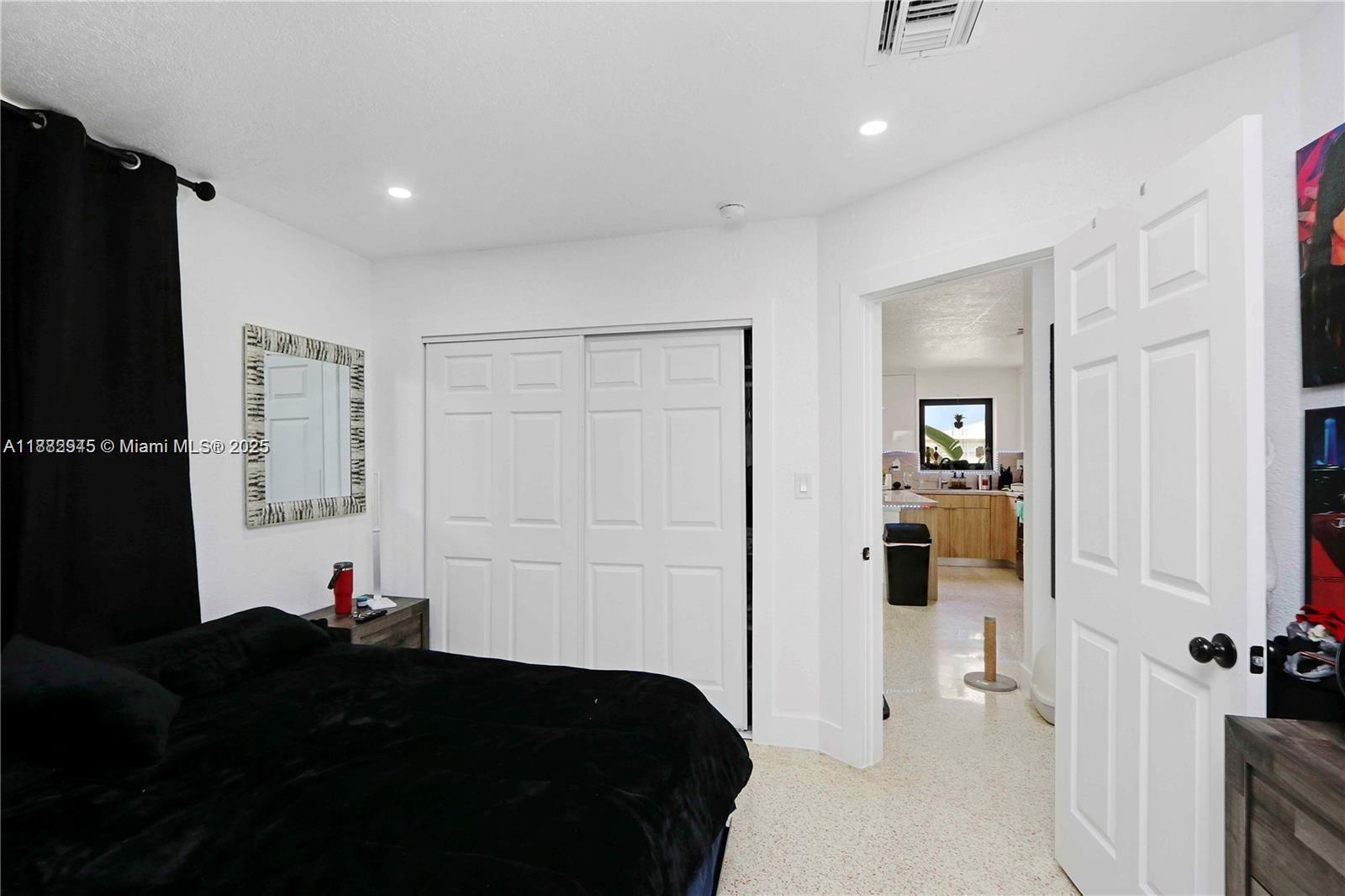 70 Northeast 186th Terrace Miami, FL 33179 - Photo 8 of 32 a bed room with a bed and a closet