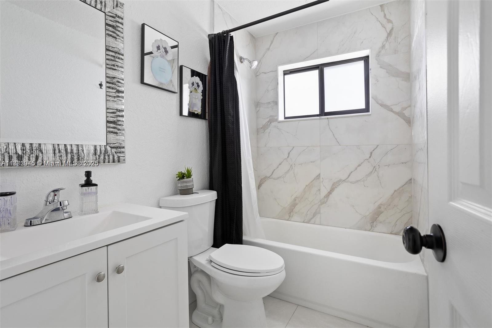 70 Northeast 186th Terrace Miami, FL 33179 - Photo 10 of 32 a bathroom with a sink a toilet and a bathtub