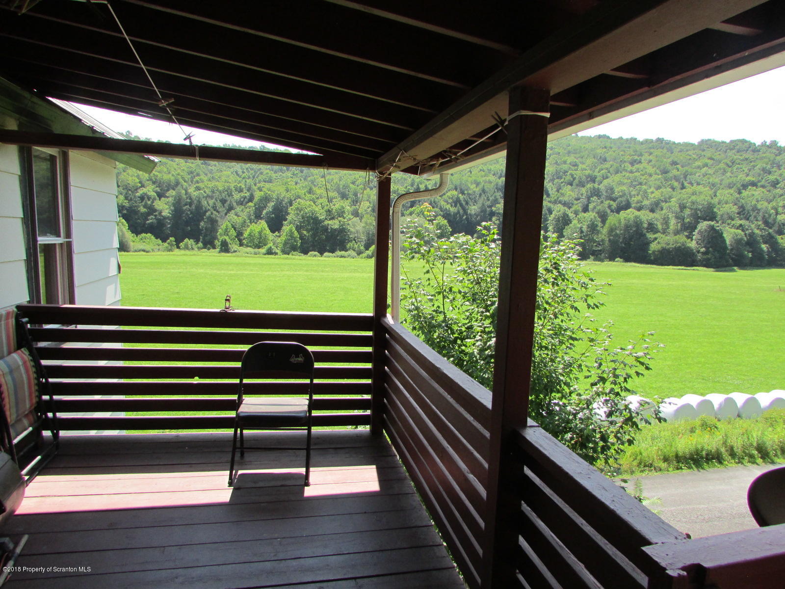 1291 White Creek Road Meshoppen, PA 18630 - Photo 3 of 24 a view of a two chairs in the balcony
