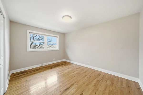 a view of room with wooden floor and window
