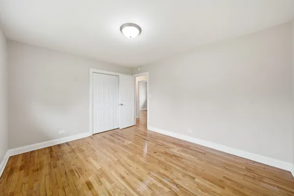 a view of an empty room and wooden floor
