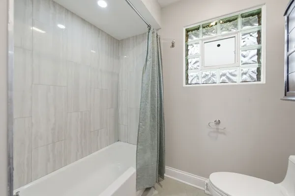 a bathroom with a toilet and shower