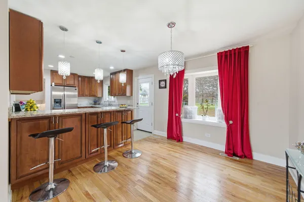 a view of a kitchen with granite countertop stainless steel appliances and dining table