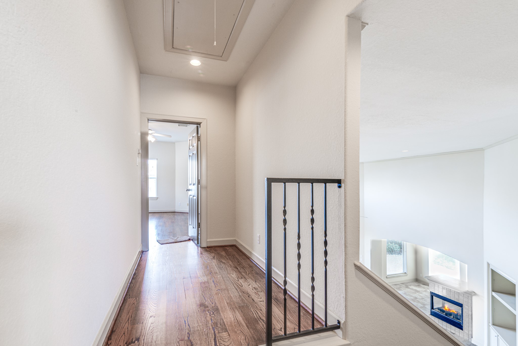 403 Harborside Way Kemah, TX 77565 - Photo 35 of 39 Upper level landing with updated iron railing and continuous wood flooring.