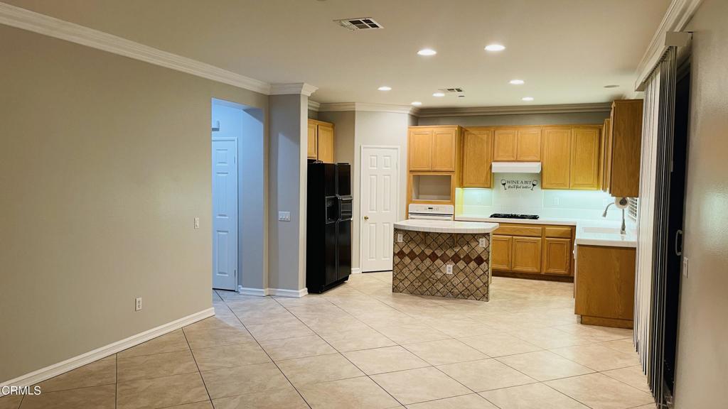 350 Huerta Street Oxnard, CA 93030 - Photo 11 of 11 a kitchen with stainless steel appliances kitchen island granite countertop a refrigerator and a stove top oven