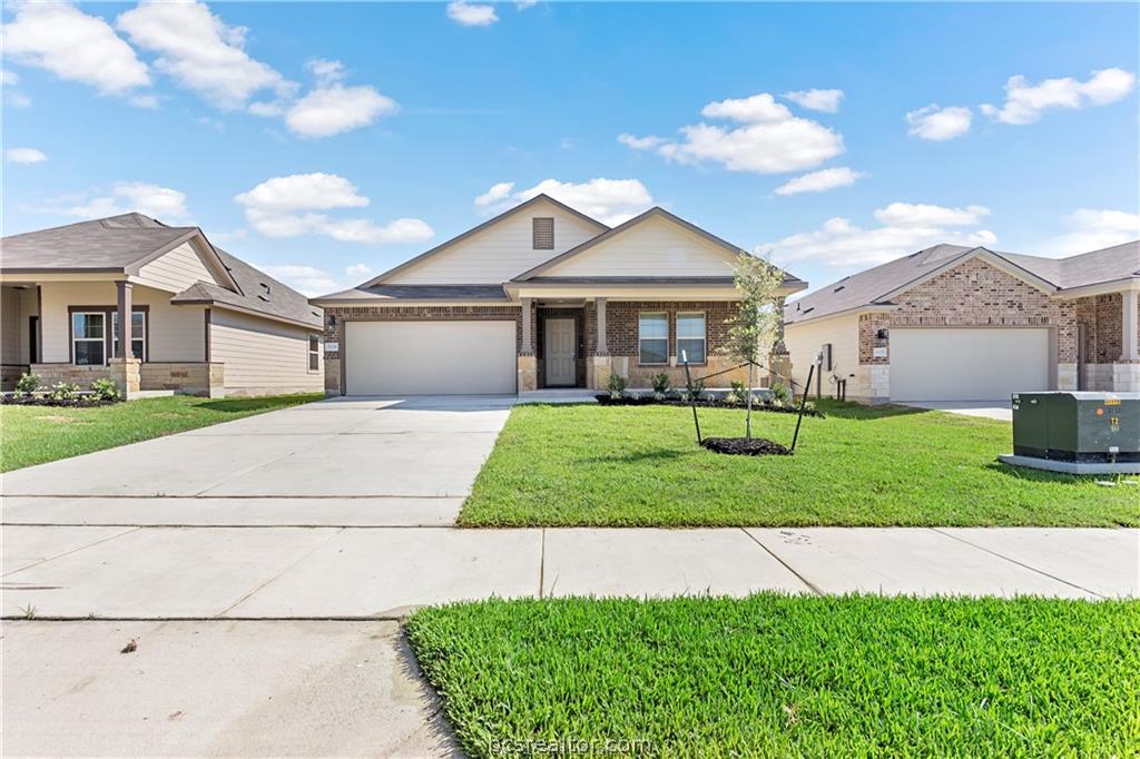 2119 Chief Street Bryan, TX 77807 - Photo 1 of 23 a front view of a house with a yard and garage