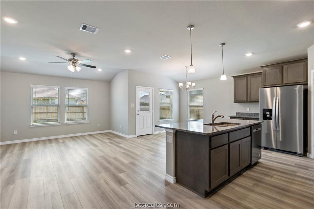 2119 Chief Street Bryan, TX 77807 - Photo 3 of 23 a kitchen with stainless steel appliances granite countertop a sink a stove and a refrigerator