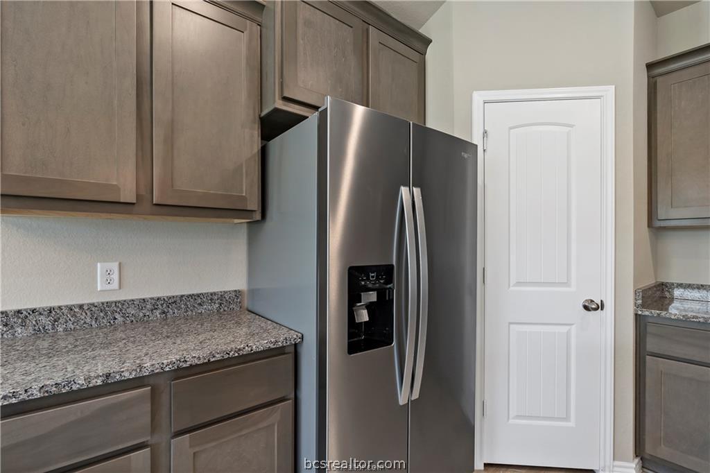 2119 Chief Street Bryan, TX 77807 - Photo 7 of 23 a kitchen with stainless steel appliances granite countertop a refrigerator and a sink