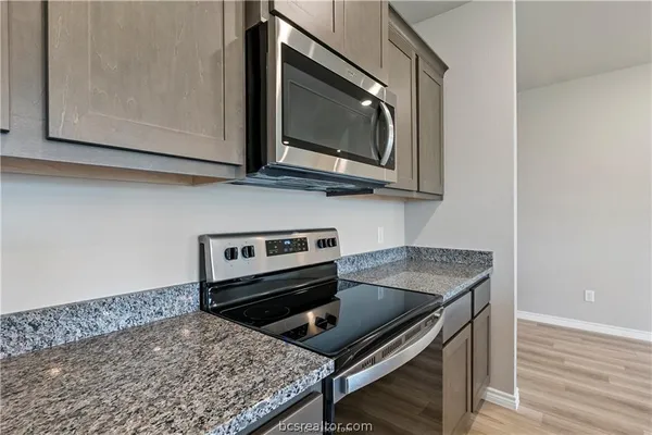 a kitchen with a stove and a microwave
