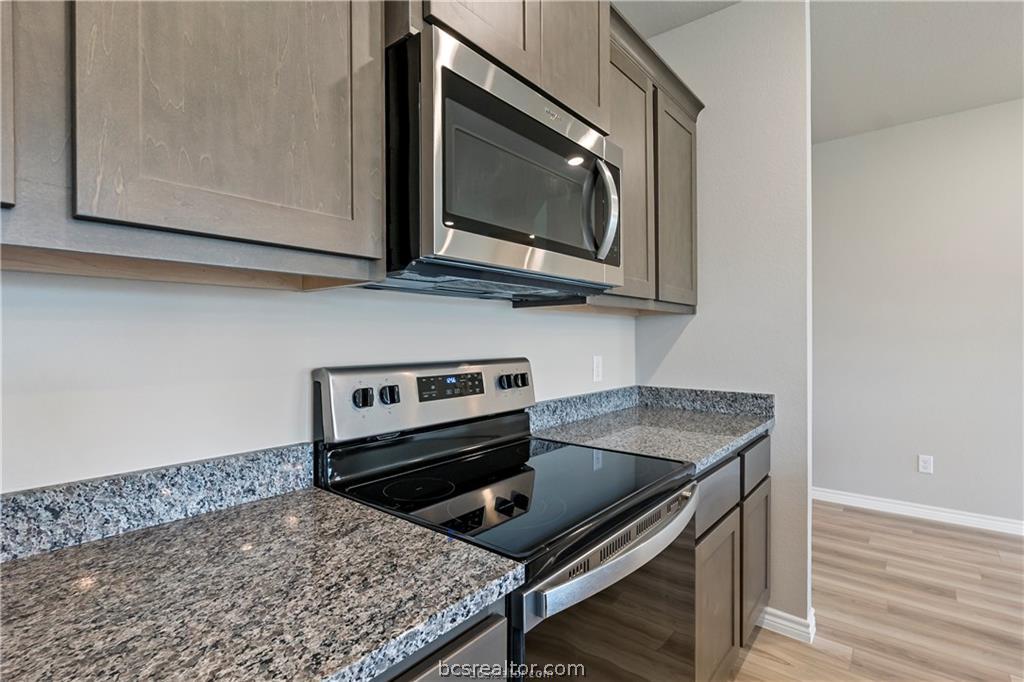 2119 Chief Street Bryan, TX 77807 - Photo 8 of 23 a kitchen with a stove and a microwave