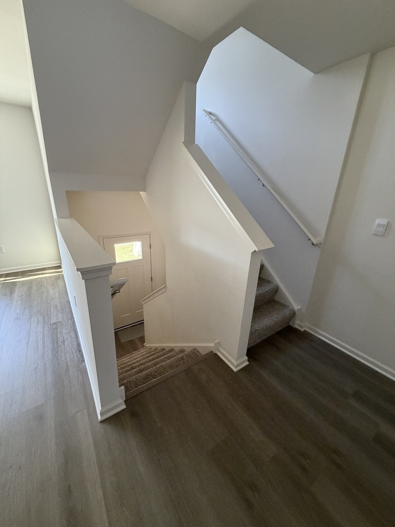 1555 Sequoia Way Pingree Grove, IL 60140 - Photo 7 of 17 a view of an empty room with wooden floor and stairs