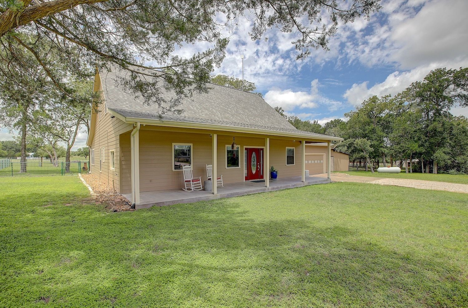 1928 Koether Road Carmine, TX 78932 - Photo 5 of 49 Main home facade with covered porch and adjacent barn with lots of trees and a peaceful country setting