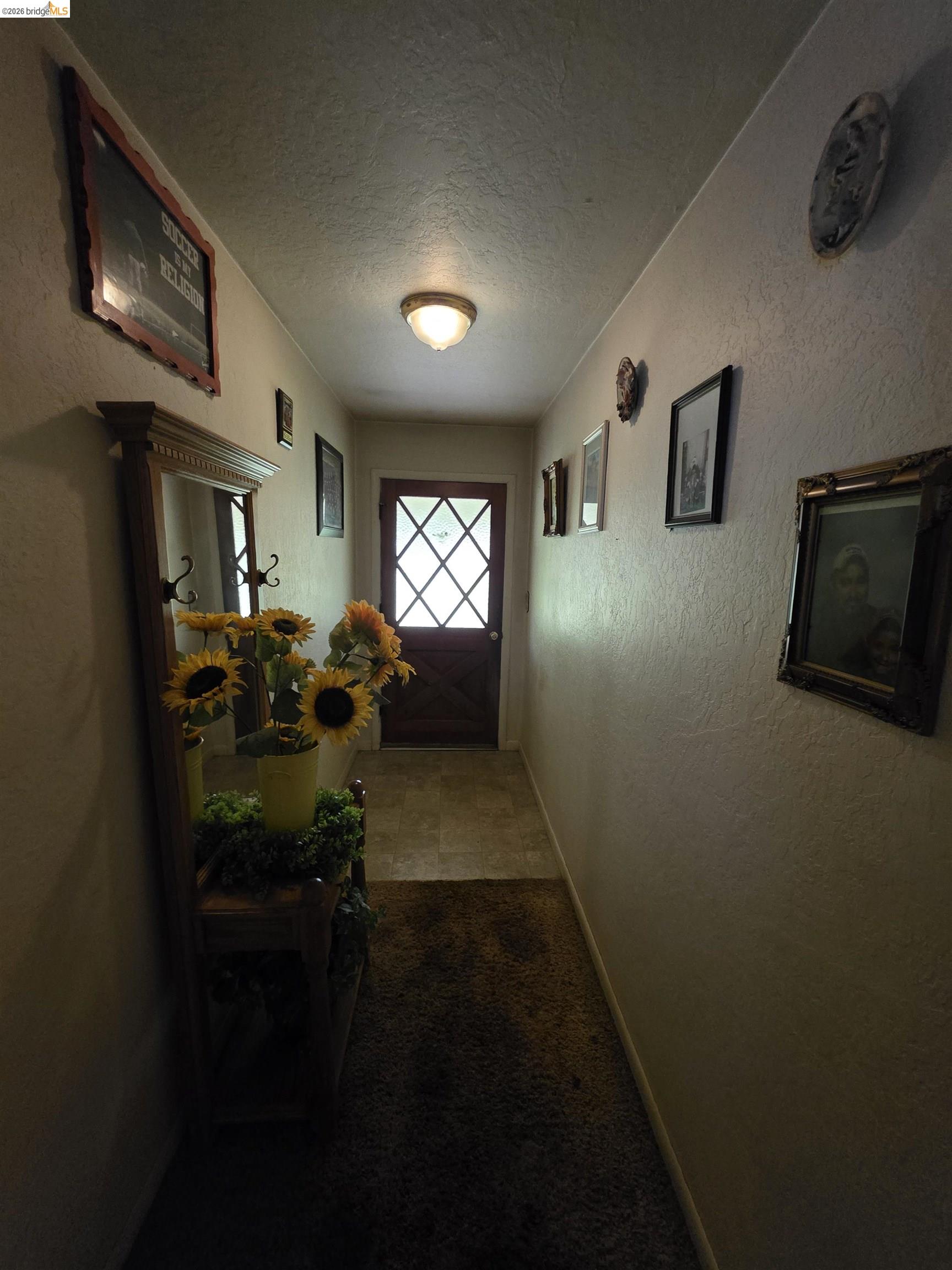 2323 Spink Road West Point, CA 95255 - Photo 7 of 17 Entryway featuring a diamond-paneled glass door with a wood finish, overhead flush-mount lighting, and a combination of carpeted and tiled flooring