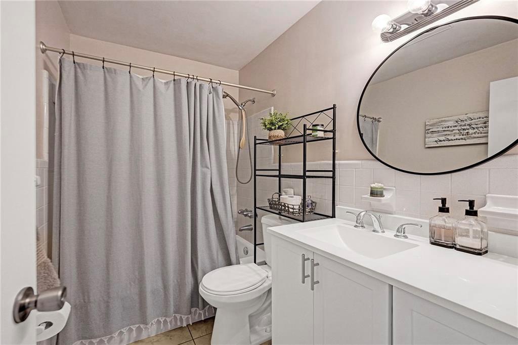 2131 Northeast 40th Court, Unit 18 Lighthouse Point, FL 33064 - Photo 12 of 36 a bathroom with a sink mirror vanity and toilet