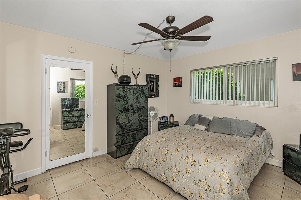 2131 Northeast 40th Court, Unit 18 Lighthouse Point, FL 33064 - Photo 22 of 36 a bedroom with a large bed and a window