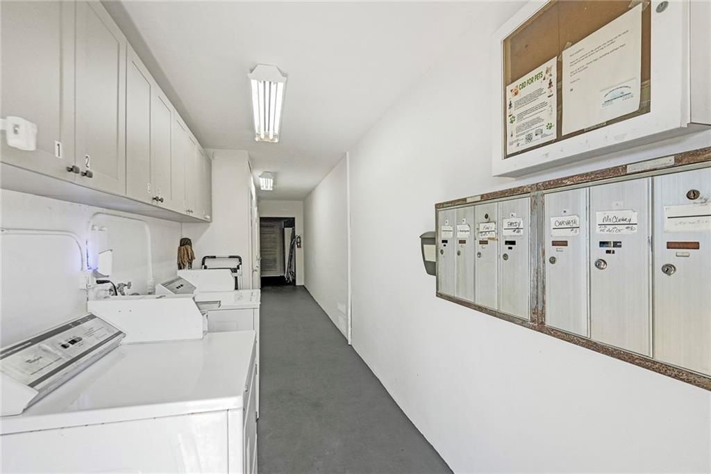 2131 Northeast 40th Court, Unit 18 Lighthouse Point, FL 33064 - Photo 5 of 36 a kitchen with white cabinets a sink a stove and a refrigerator