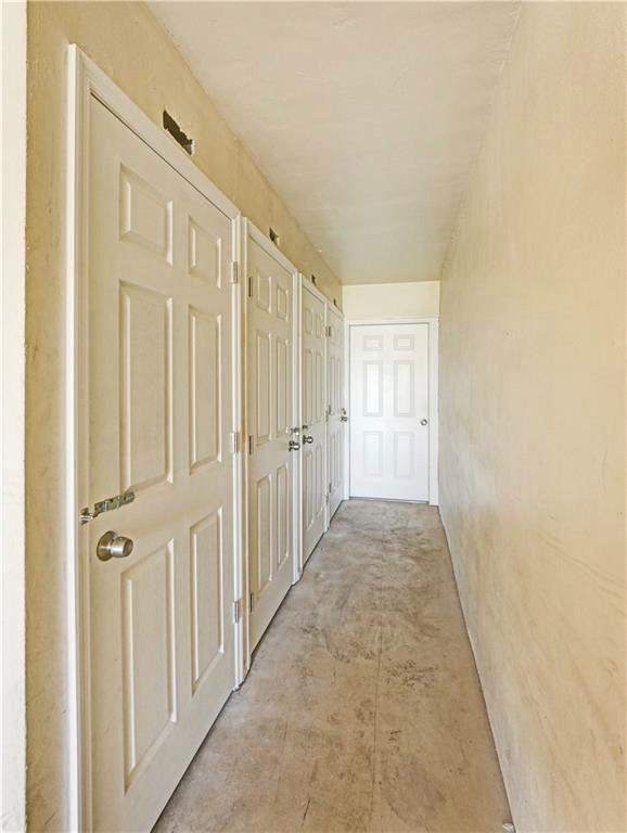 2131 Northeast 40th Court, Unit 18 Lighthouse Point, FL 33064 - Photo 6 of 36 a view of a hallway with wooden floor and closet area