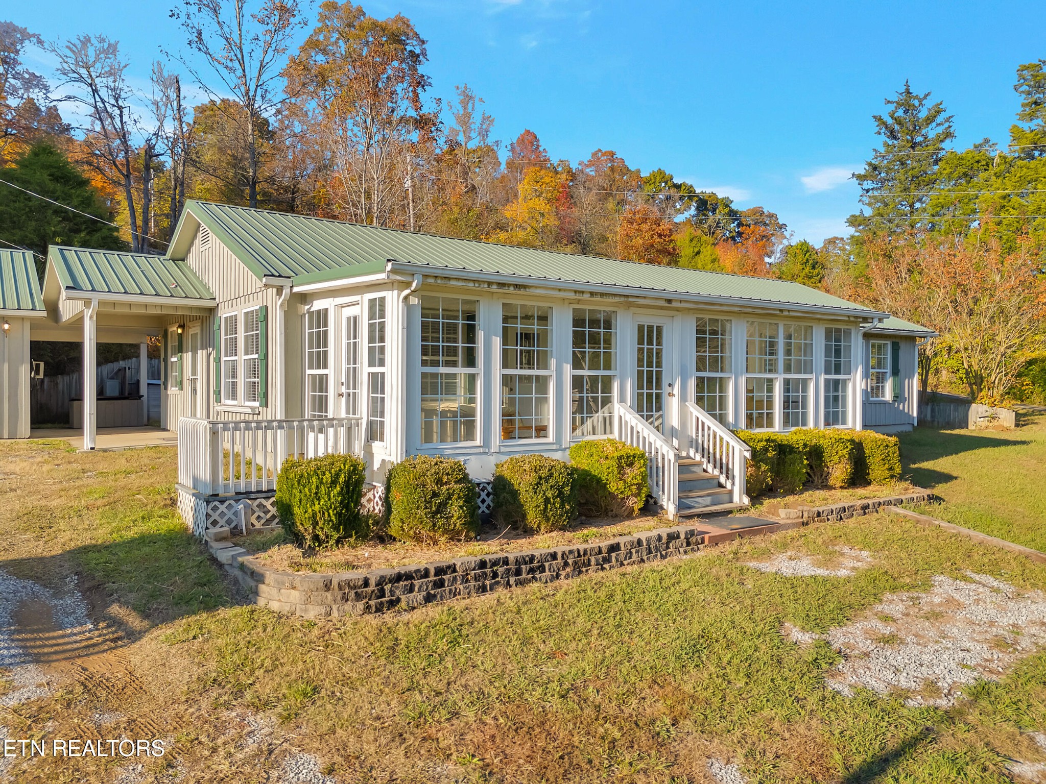 9256 Hines Valley Road Lenoir City, TN 37771 - Photo 2 of 46 a front view of a house with swimming pool and porch