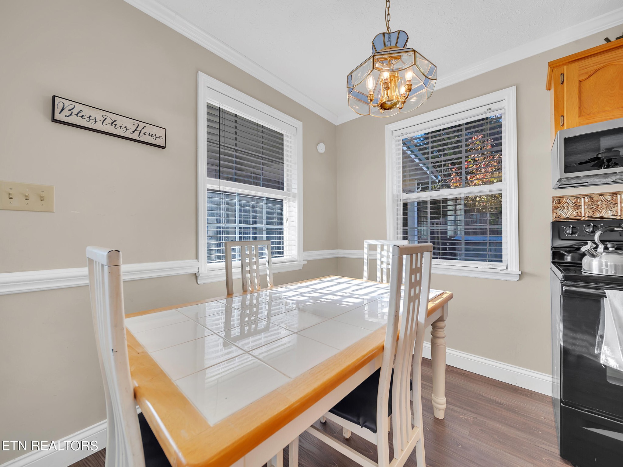 9256 Hines Valley Road Lenoir City, TN 37771 - Photo 21 of 46 a view of a dining room with furniture window and wooden floor