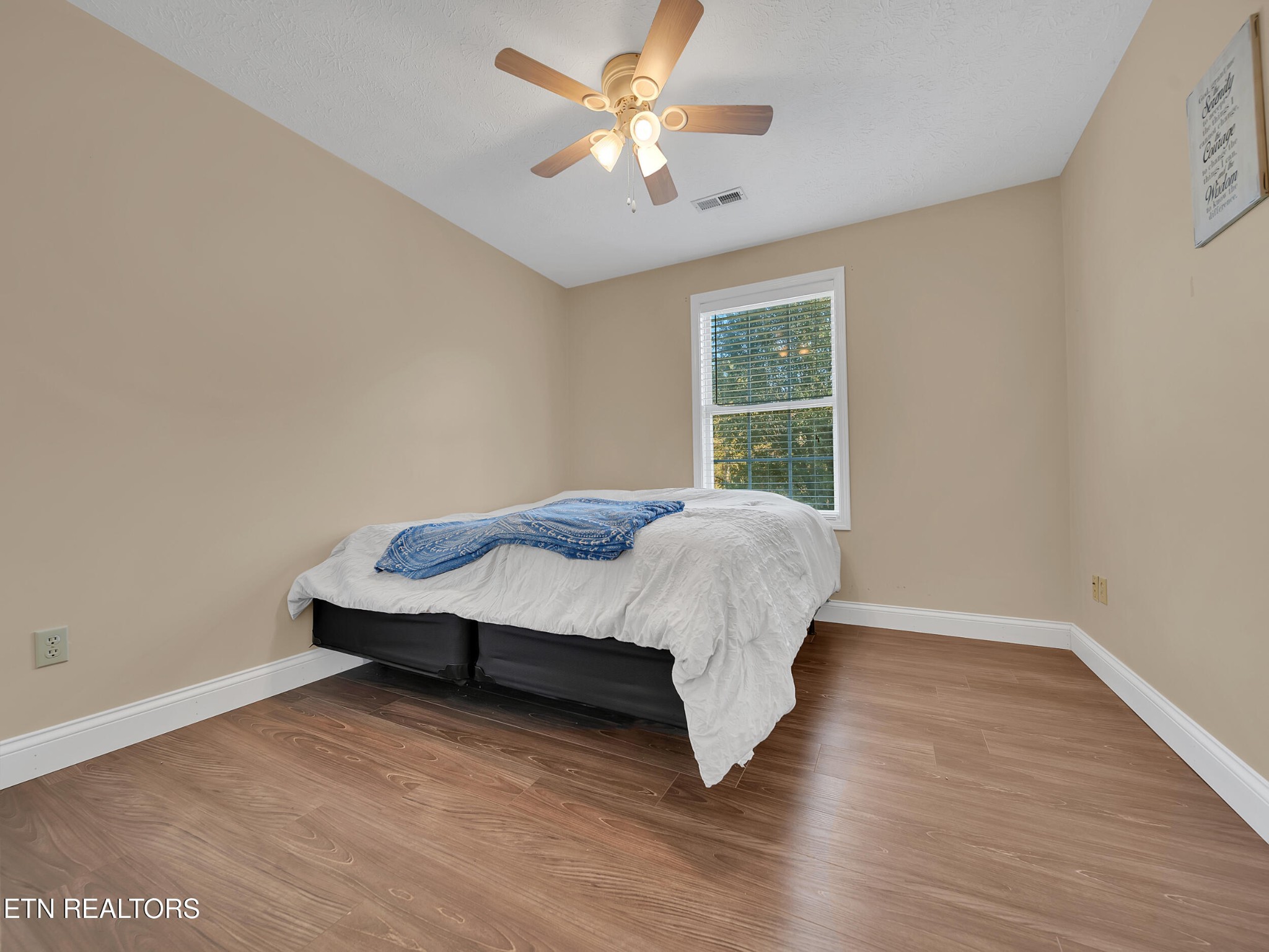 9256 Hines Valley Road Lenoir City, TN 37771 - Photo 24 of 46 a bedroom with a bed and a ceiling fan