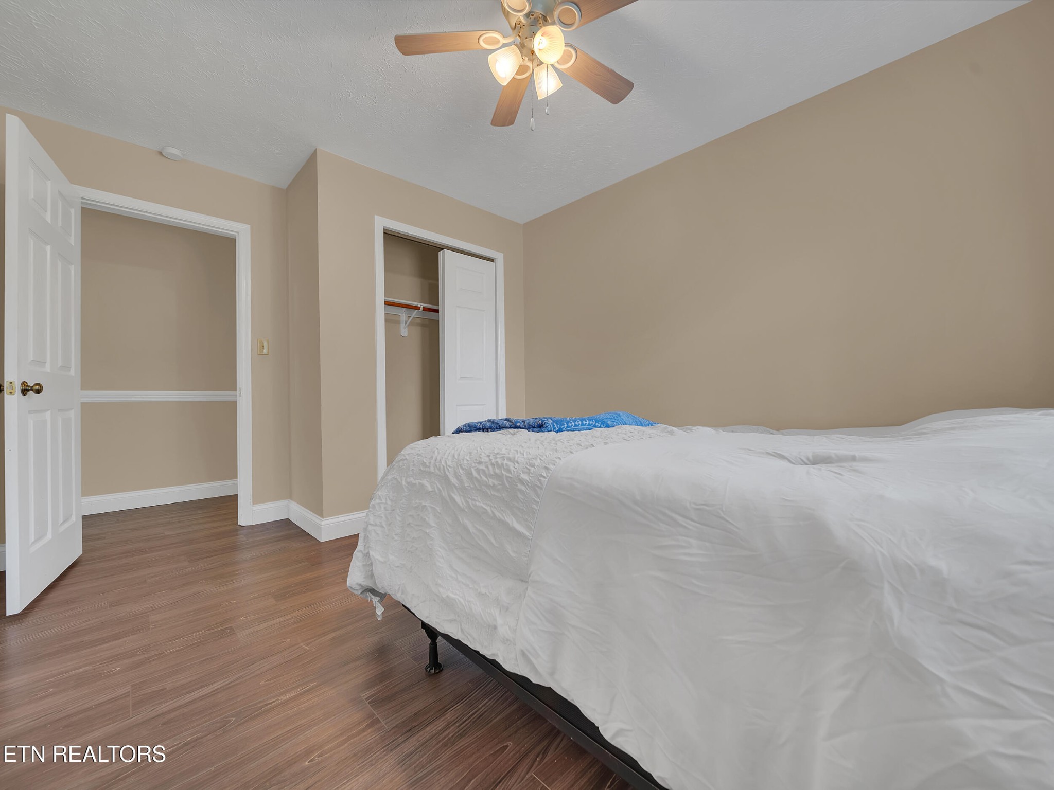 9256 Hines Valley Road Lenoir City, TN 37771 - Photo 25 of 46 a bedroom with a bed and a chandelier