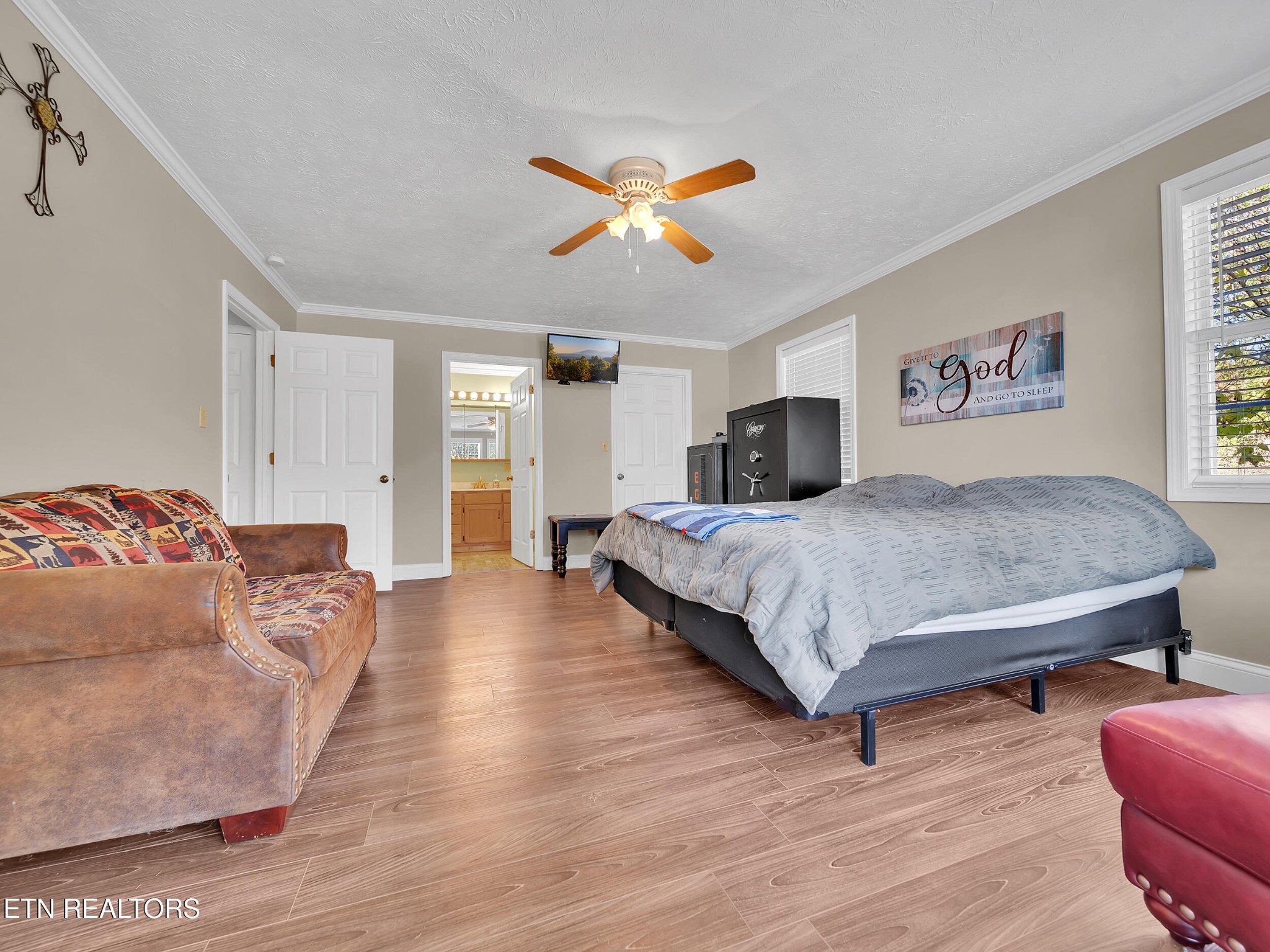9256 Hines Valley Road Lenoir City, TN 37771 - Photo 27 of 46 a spacious bedroom with a bed and a chandelier