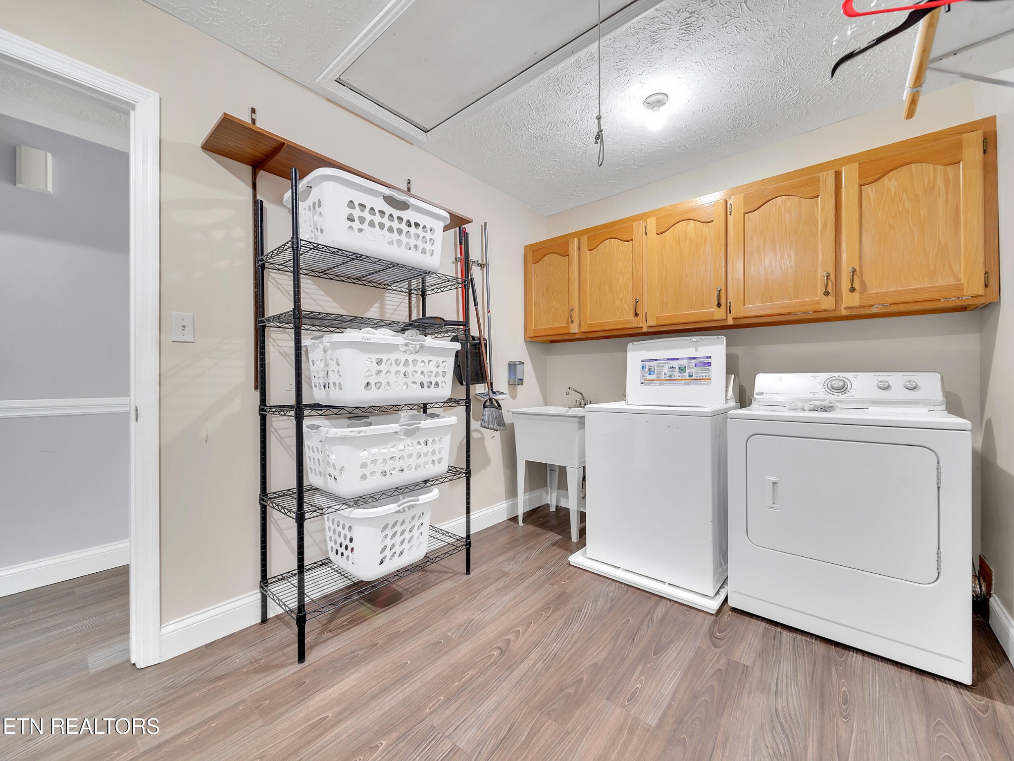9256 Hines Valley Road Lenoir City, TN 37771 - Photo 33 of 46 a kitchen with white cabinets and wooden floor