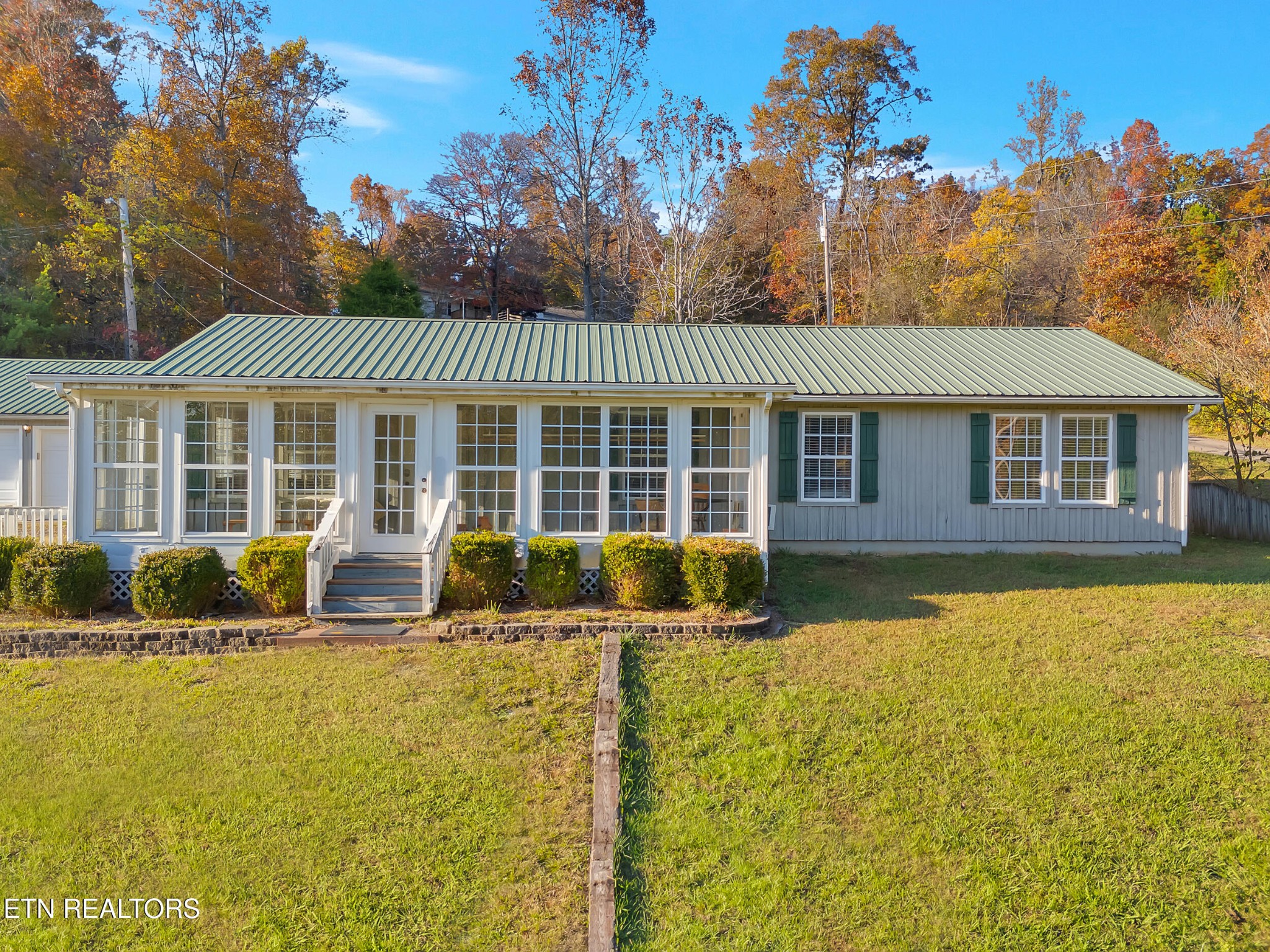 9256 Hines Valley Road Lenoir City, TN 37771 - Photo 4 of 46 a front view of a house with a yard table and chairs