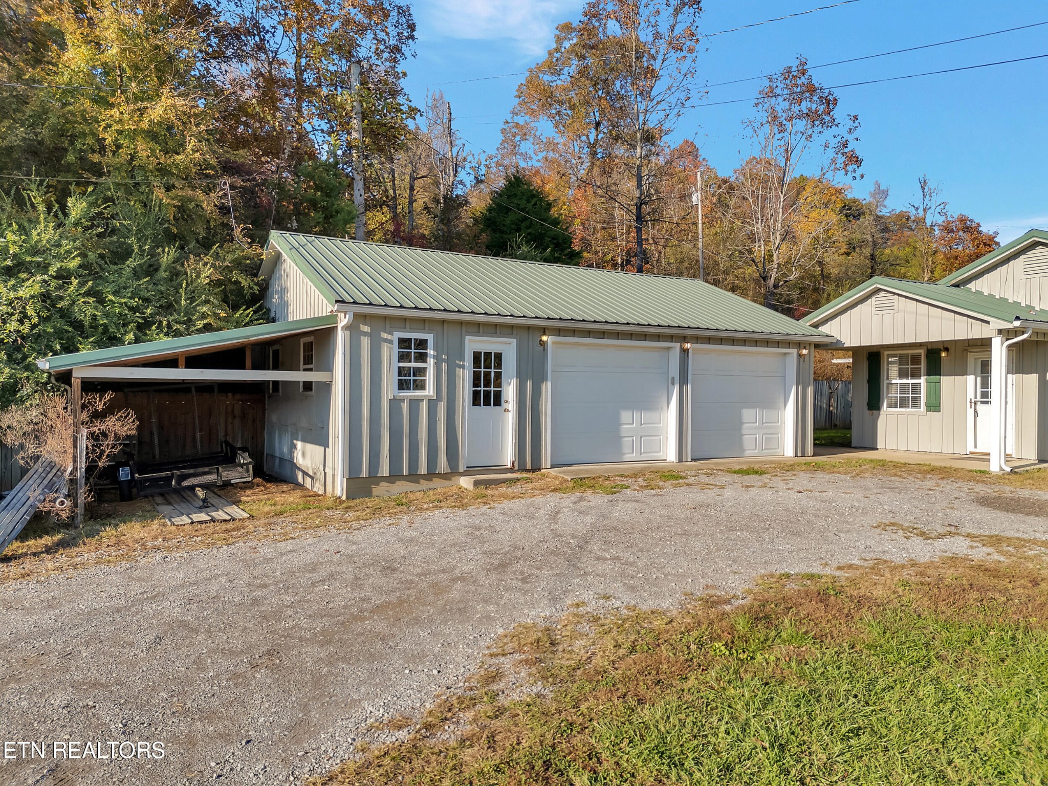 9256 Hines Valley Road Lenoir City, TN 37771 - Photo 5 of 46 a front view of a house with a yard and garage